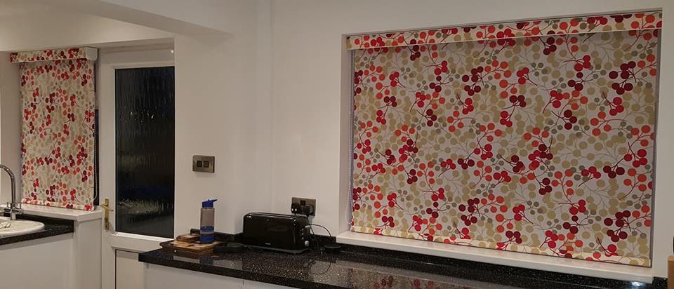 Colour full roller blinds installed in a kitchen